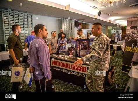 A Young Hispanic Man Talks With A U S Army National Guard Recruiter A Young Hispanic Man Talks With A U S Army National Guard Recruiter