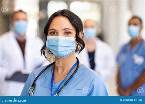 Home Health Care Nurse Wearing A Medical Face Mask Entering A Client S Home Health Care Nurse Wearing A Medical Face Mask Entering A Client S