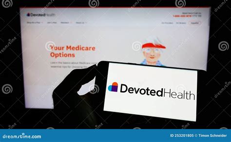 Person Holding Cellphone With Webpage Of Us Health Care Company